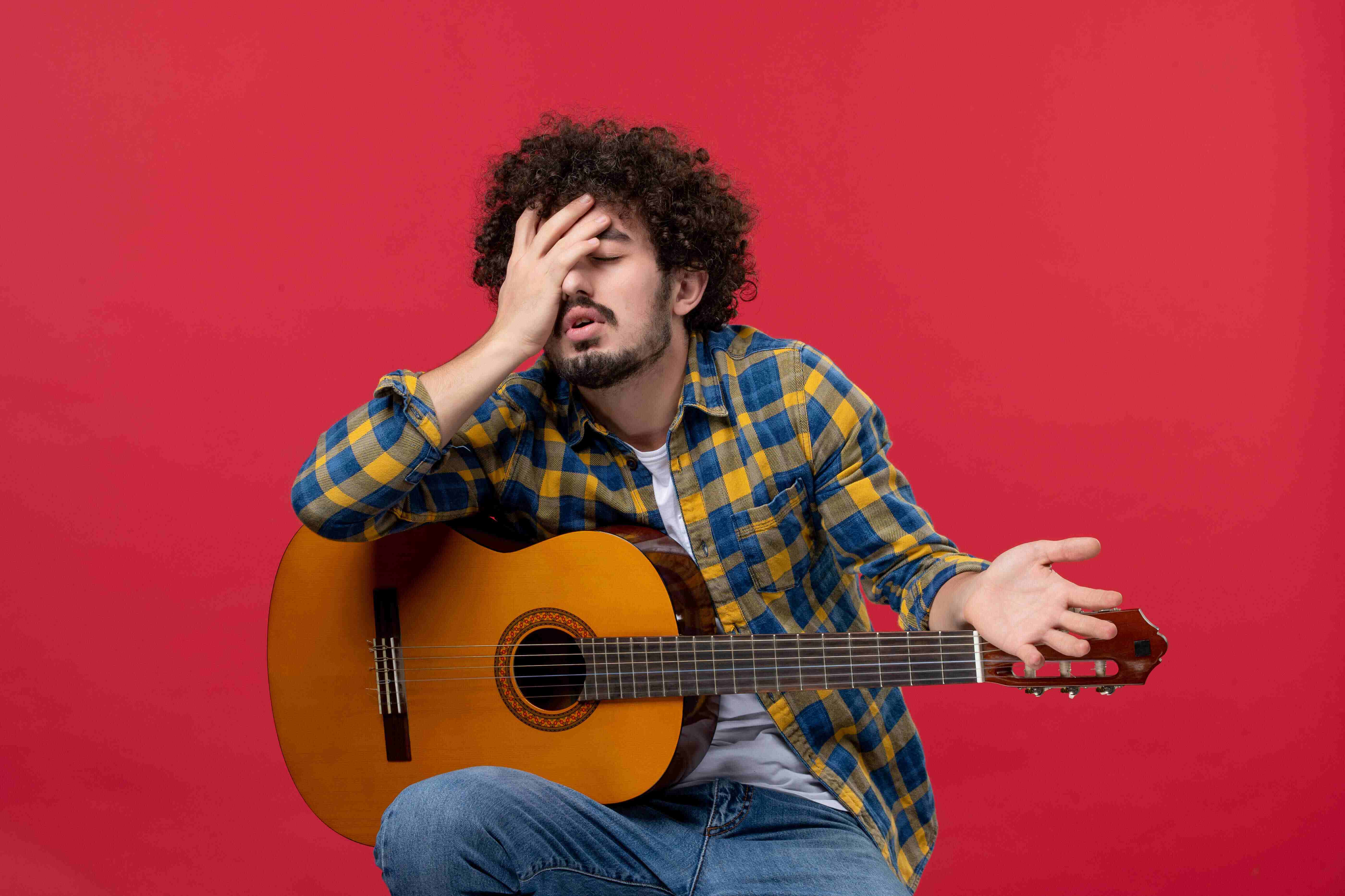 man confused with guitar image